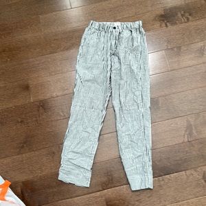Pinstripe pants, elastic waist, front zipper and button, no pockets,
